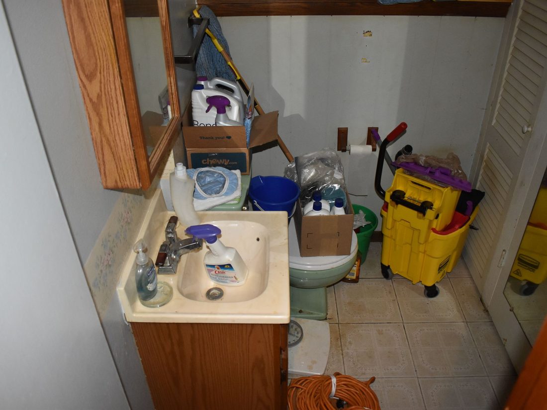 Lower-level half bath being used for storage before renovation