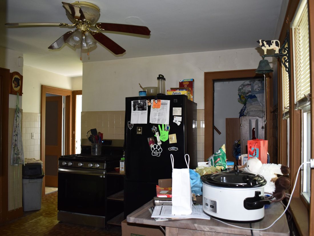 Second kitchen view showing the layout and stored belongings