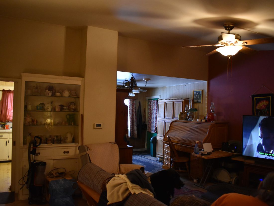 Cudahy living room packed with furniture and belongings before the sale