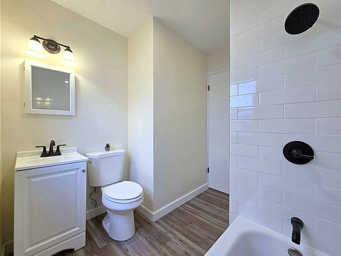 New bathroom with subway-tile tub surround and black fixtures