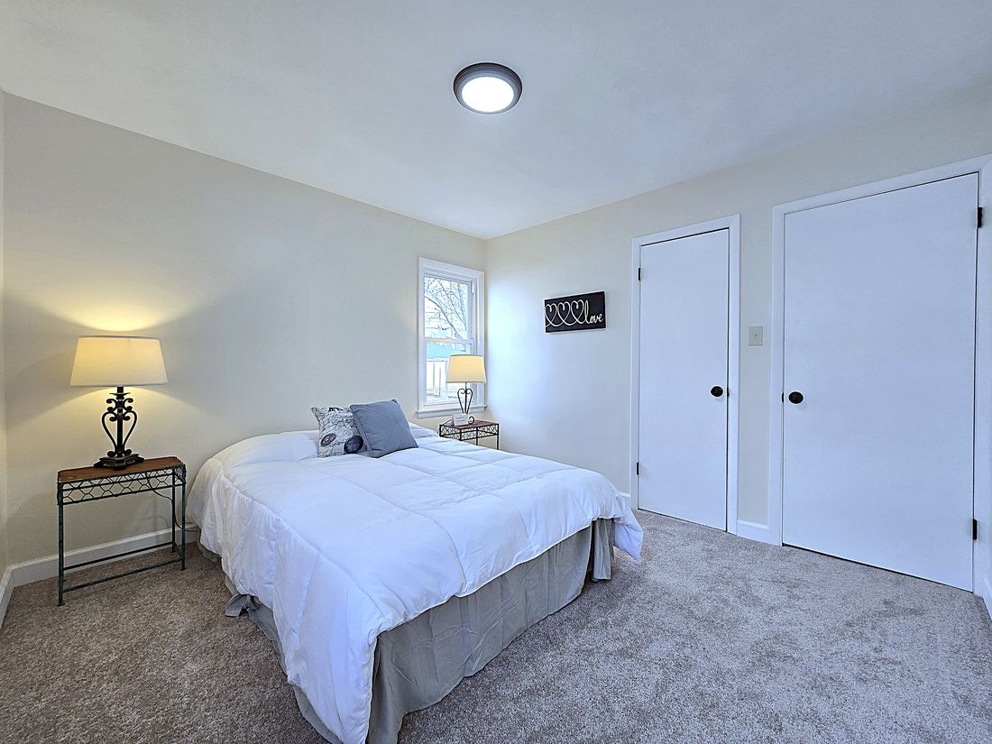 Renovated bedroom with new carpet, paint and lighting