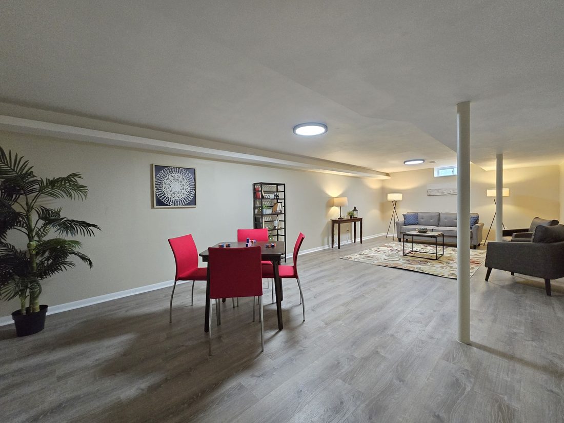 Finished lower level with new flooring and a dining area in a renovated Milwaukee home