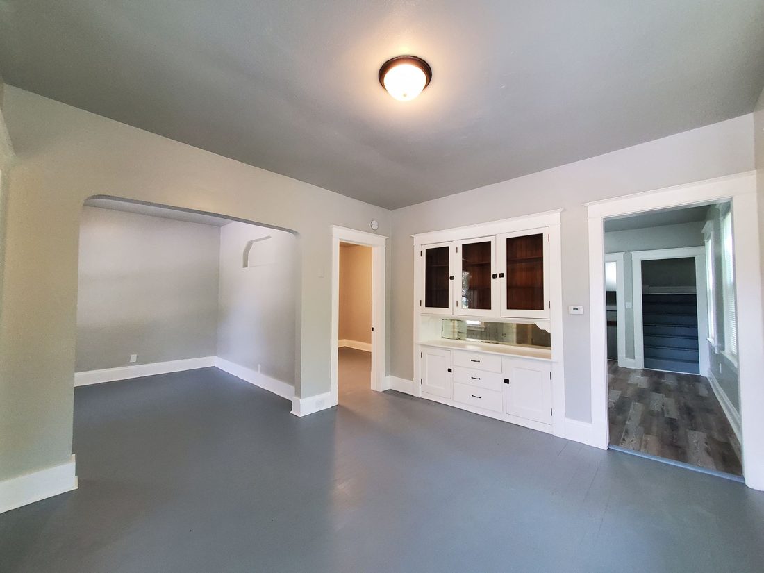 Empty renovated dining room with a restored built-in china cabinet in a Milwaukee home
