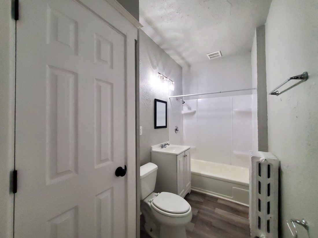 Remodeled main-floor bathroom with new tub, vanity and flooring