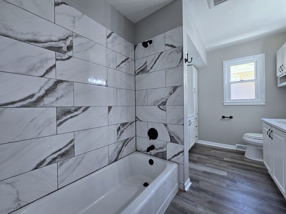 Second view of the remodeled bathroom with new vanity and fixtures