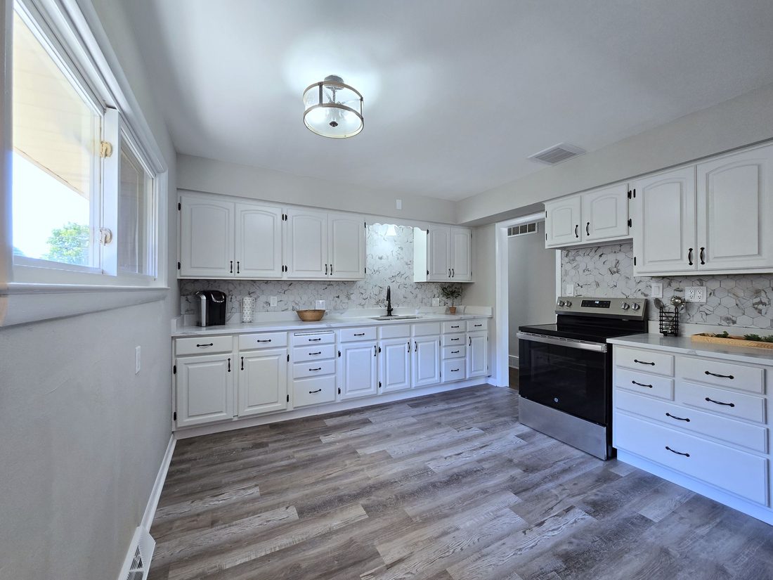 Fully renovated white kitchen with quartz counters in a Milwaukee home