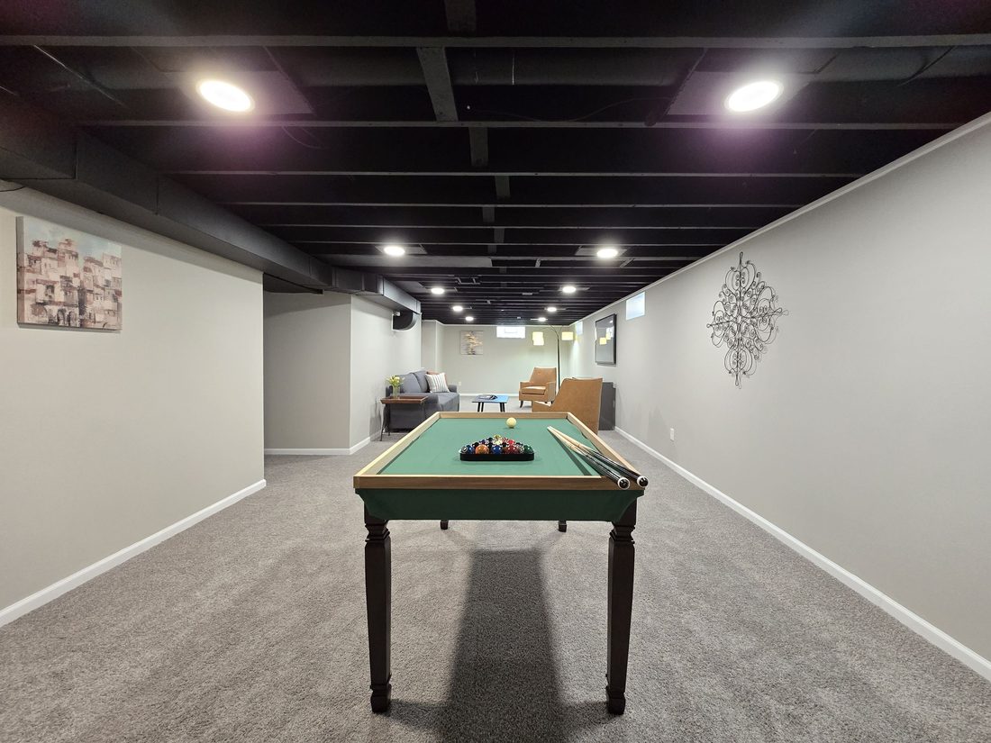 Finished lower-level rec room with a pool table in the Milwaukee ranch