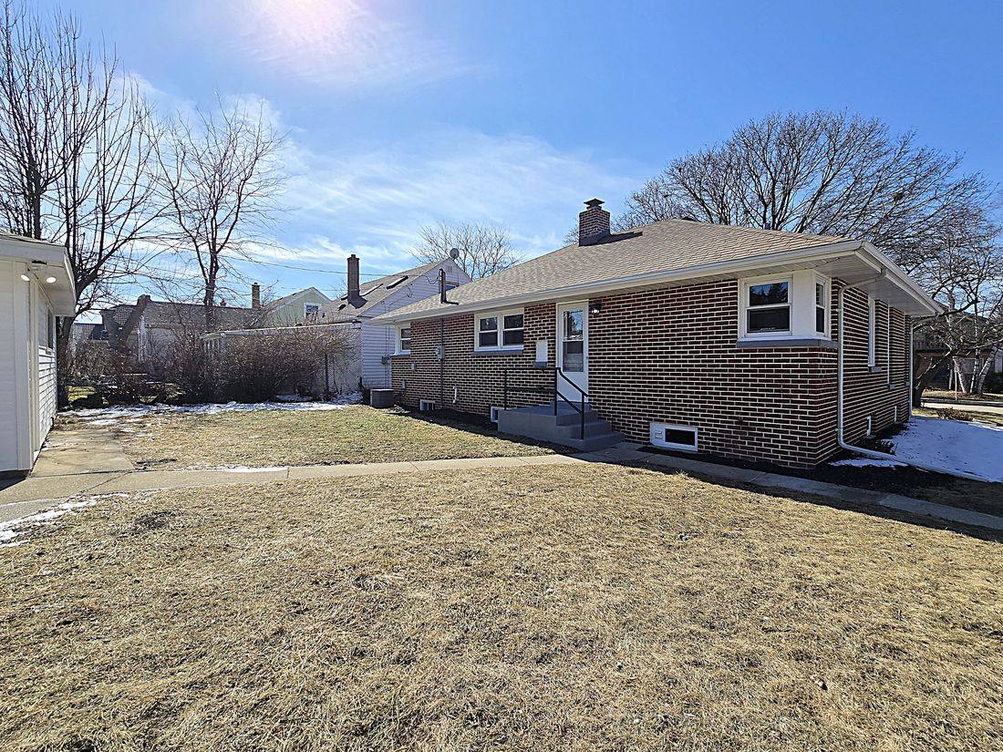 Cleaned-up backyard and rear of the brick ranch after renovation