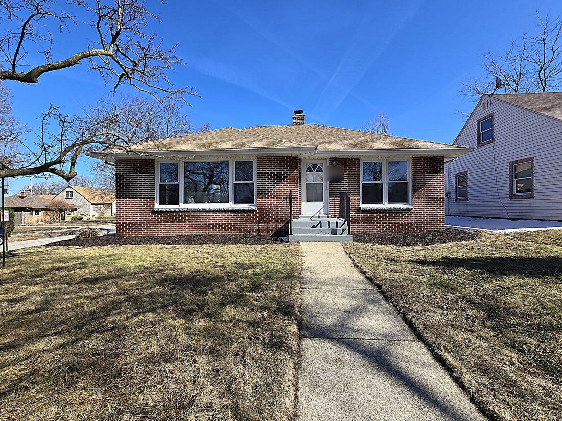 Renovated brick ranch in St. Francis with new landscaping and front steps