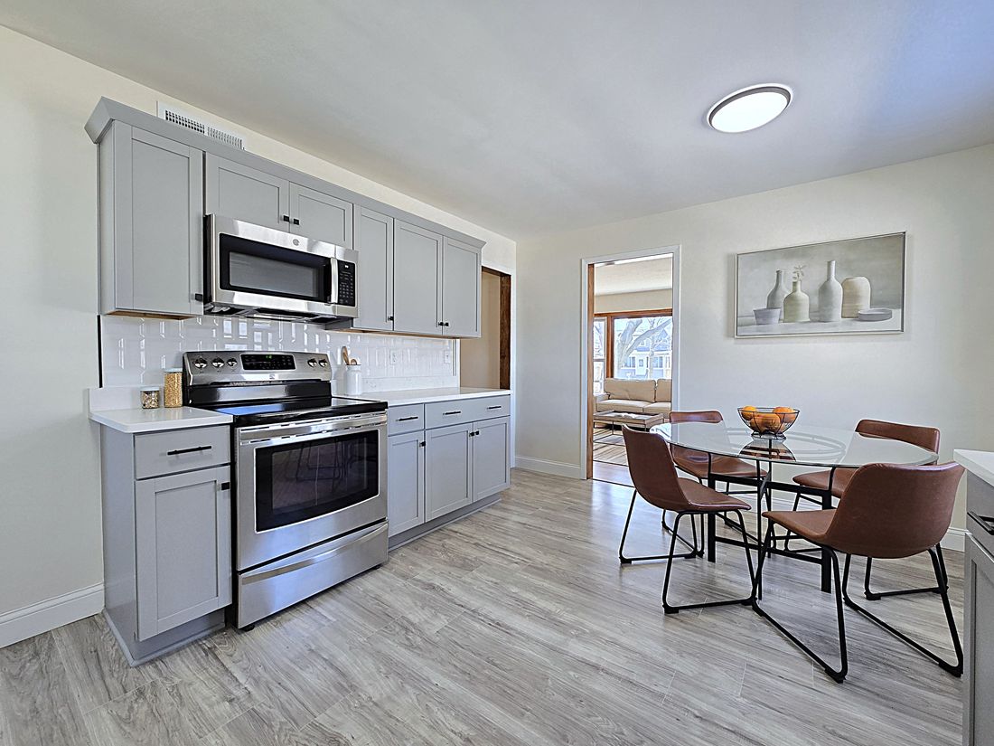 All-new kitchen with grey shaker cabinets, quartz counters and stainless appliances