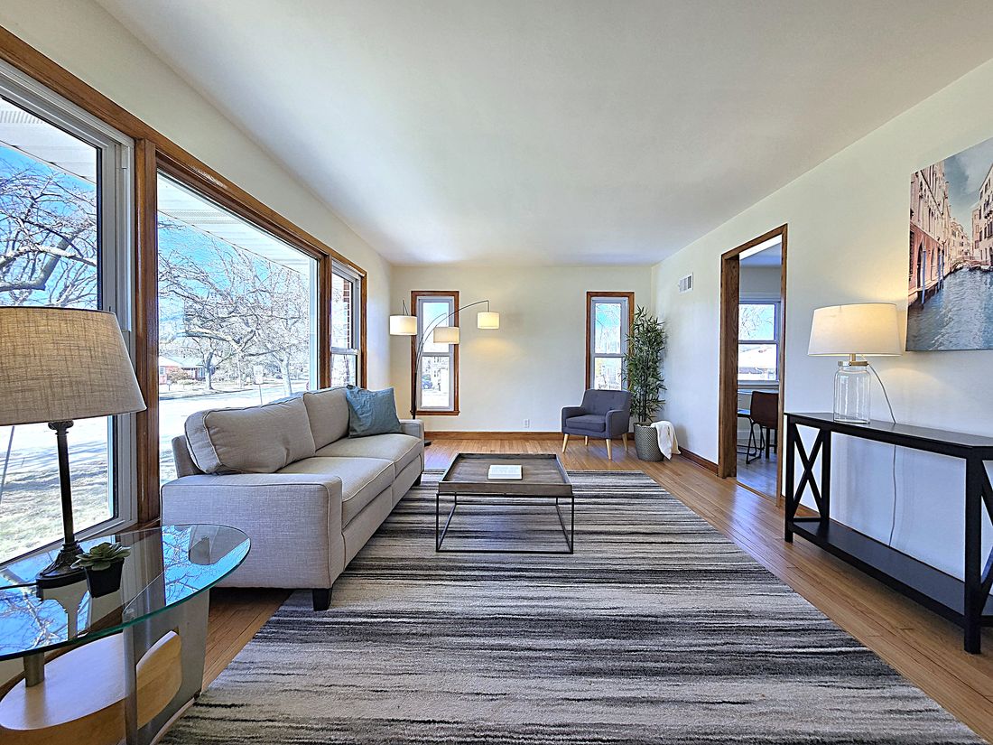 Refinished hardwood floors and fresh paint in the staged living room