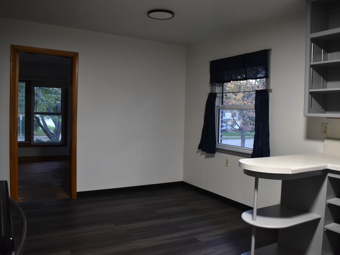 Dinette area with built-in shelving off the kitchen