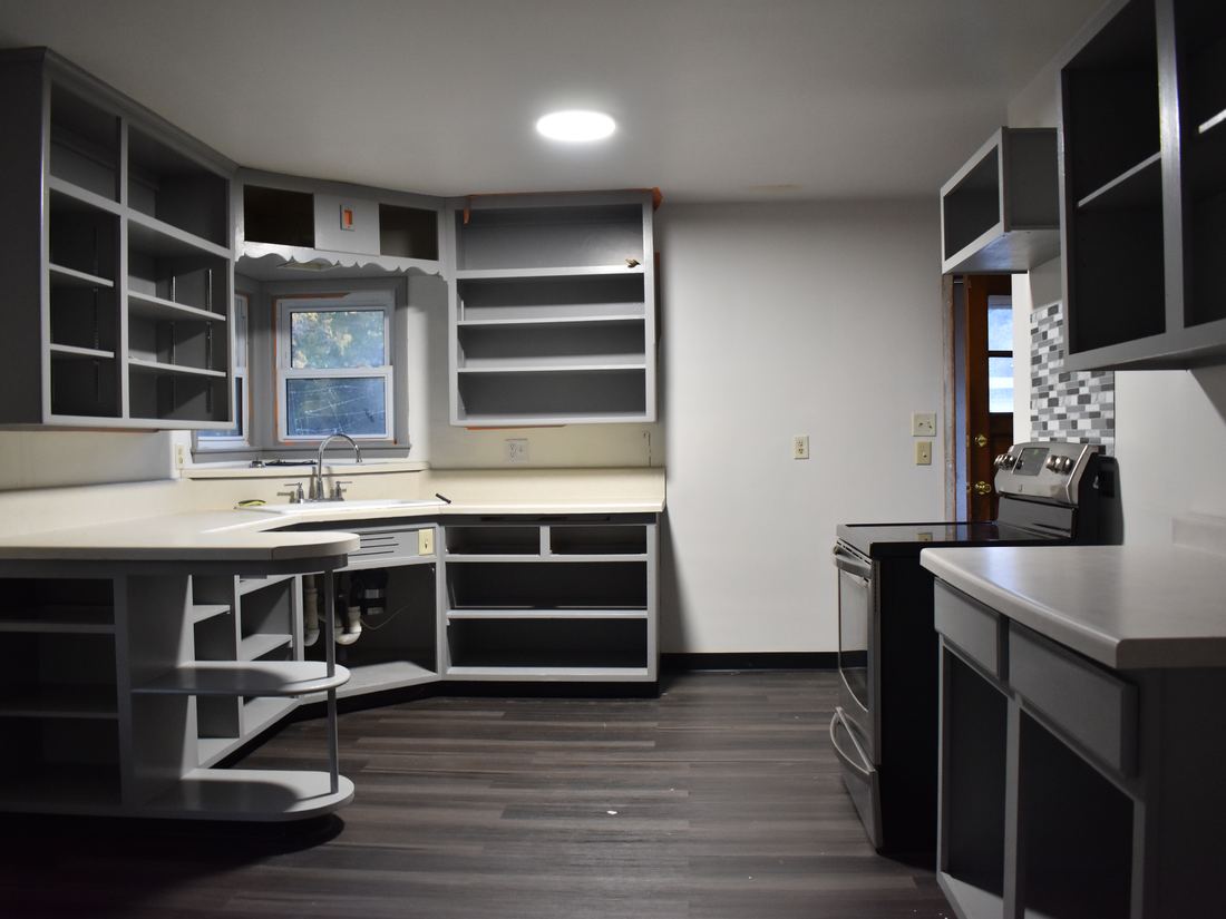 Kitchen with cabinet doors removed in the St. Francis ranch