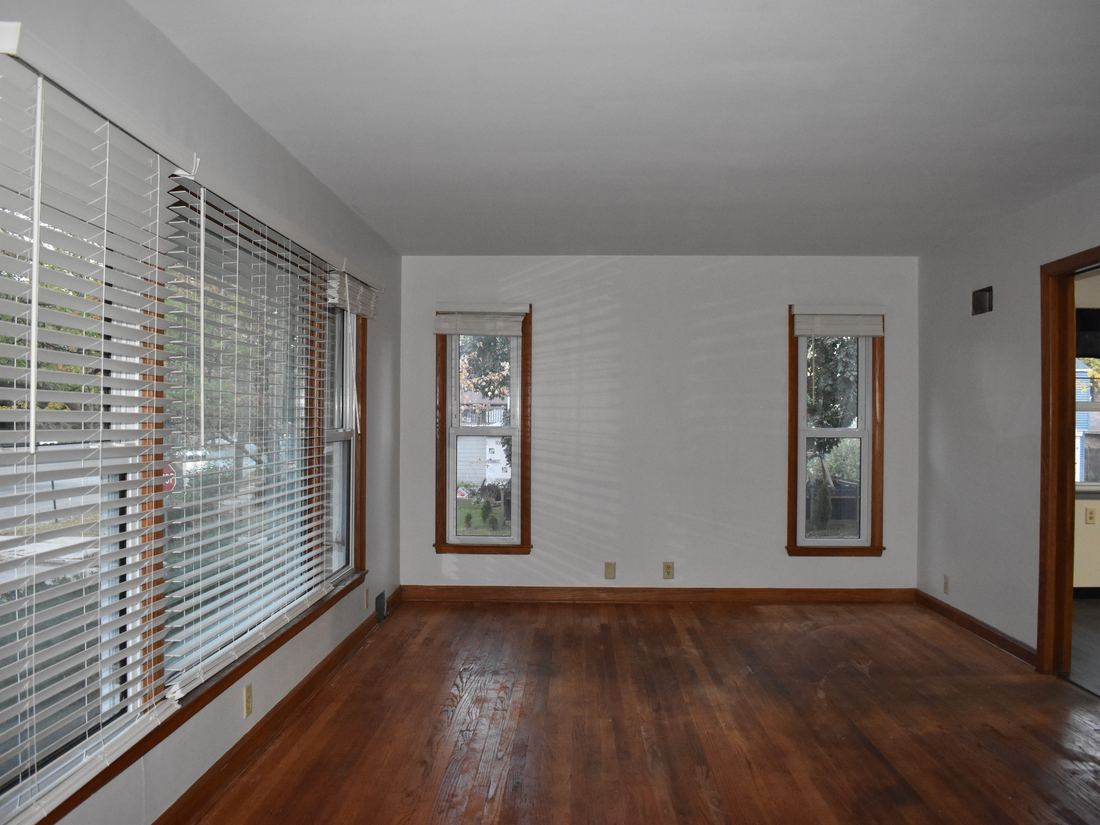 Empty living room with original hardwood floors