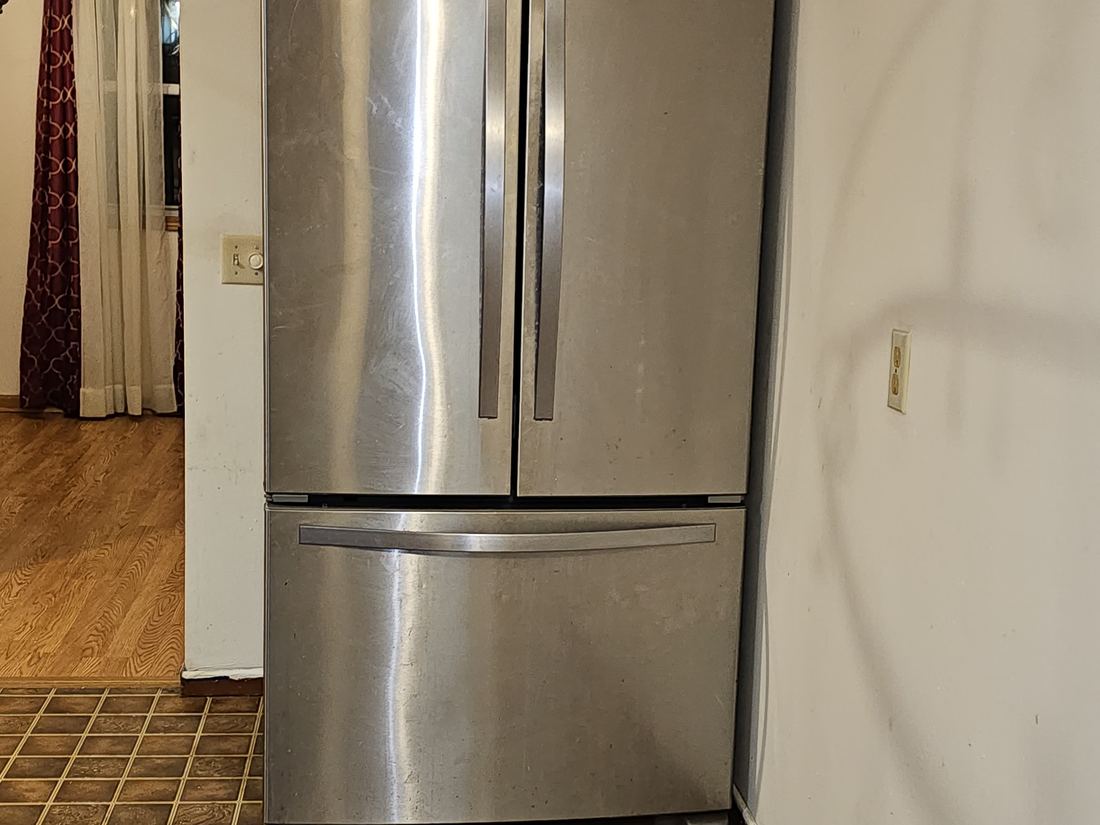 Kitchen with the original tile floor and dated finishes