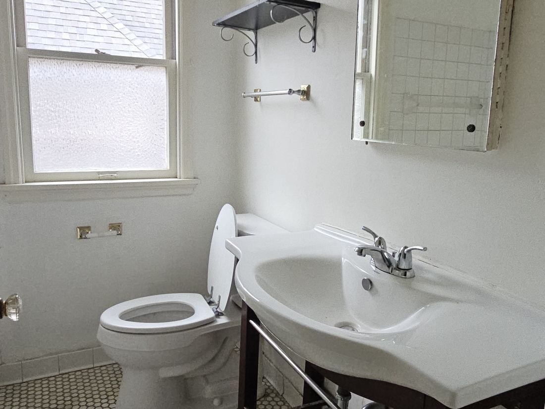 Hex-tile bathroom with original fixtures