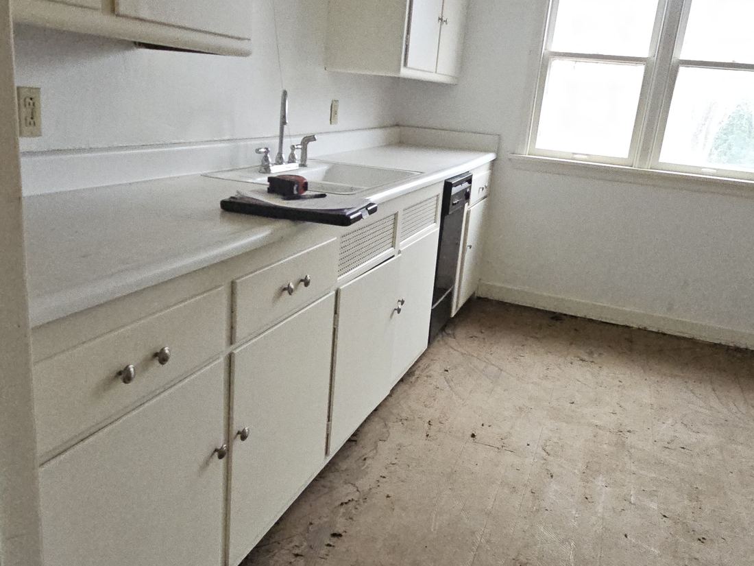 Original painted kitchen cabinetry before renovation